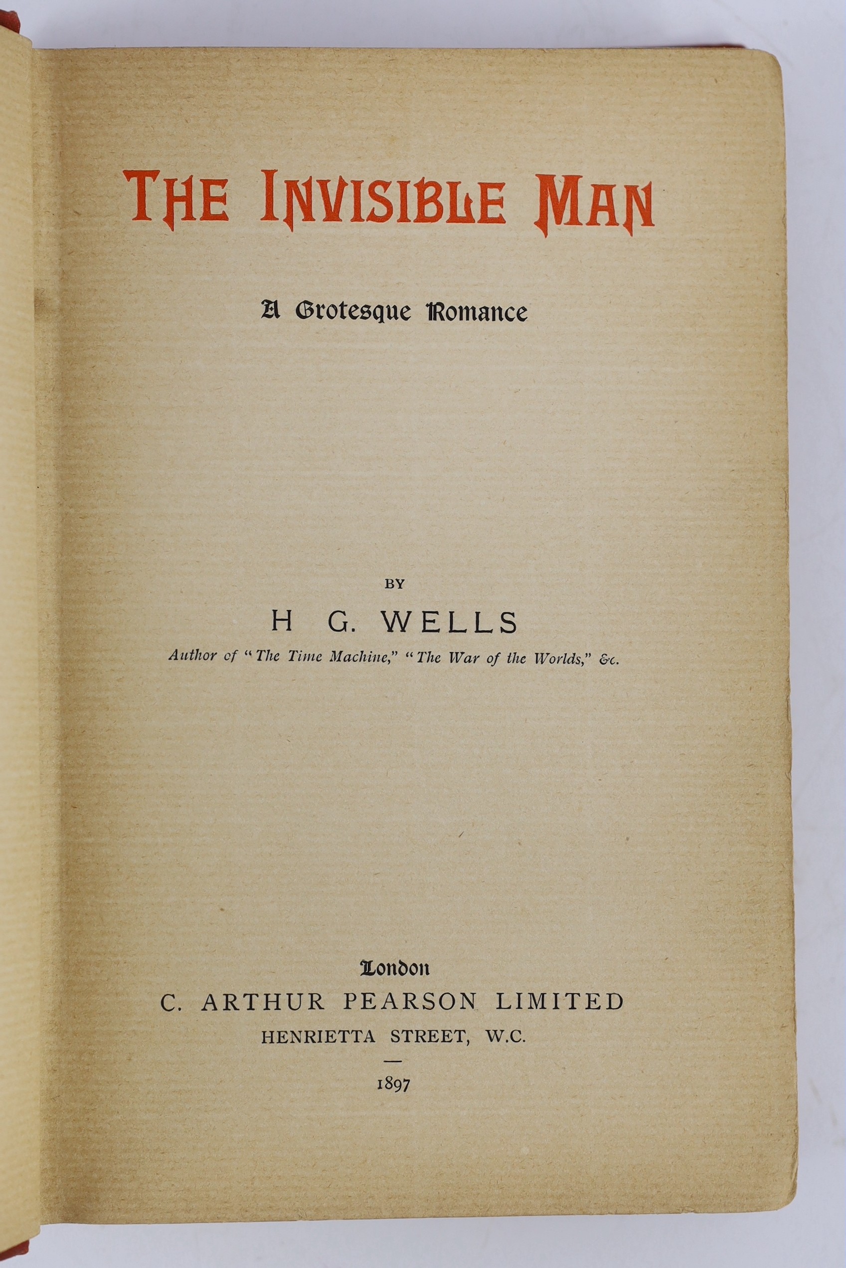 Wells, H.G - The Invisible Man, 1st edition in book form, 8vo, half title, title printed red and black, 2 pages of adverts at end, original pictorial red cloth stamped in black and gilt, inner joints split, final leaf al